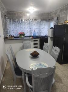 a small kitchen with a white table and chairs at Sweet beach apartment in San Felipe de Puerto Plata