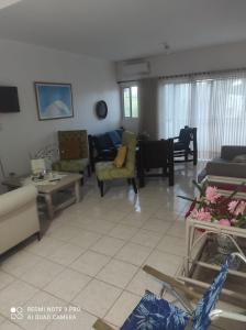a living room with couches and chairs at Sweet beach apartment in San Felipe de Puerto Plata