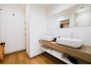 a bathroom with two sinks and a mirror at HOTEL ALL IN Kumamoto - Vacation STAY 55117v in Hanabatachō +5 photos