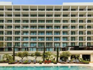 an exterior view of a hotel with a swimming pool at Mercure Benidorm in Benidorm