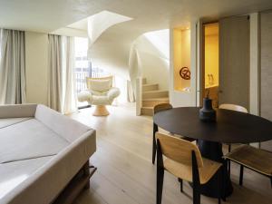 a living room with a couch and a table at Mercure Benidorm in Benidorm +169 photos