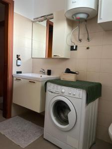 a washing machine in a kitchen with a sink at Studio apartment near Pordenone Fiera 