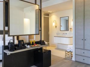 a hotel room with a kitchen and a bathroom at Mercure Benidorm in Benidorm +186 photos