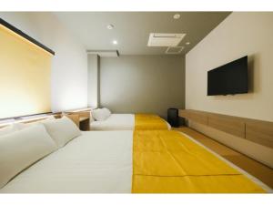 a room with two beds and a flat screen tv at HOTEL ALL IN Kumamoto - Vacation STAY 55074v in Hanabatachō
