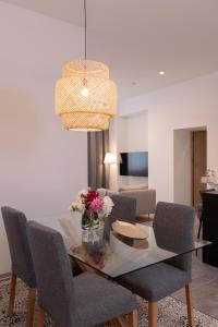 a dining room with a glass table and chairs at Suite Nr 4 - J26 LUXURY APARTMENT, Jauniela 26 Old Riga - TOP Location - 2BDR - 80m2 in Rīga