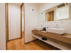 a bathroom with two white sinks and a mirror at HOTEL ALL IN Kumamoto - Vacation STAY 55141v in Hanabatachō
