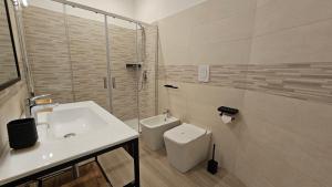 a bathroom with a sink and a toilet and a shower at Talenti Suites Rome Casa Vacanze in Rome