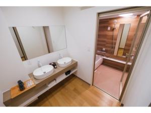 a bathroom with two sinks and a shower at HOTEL ALL IN Kumamoto - Vacation STAY 55144v in Hanabatachō