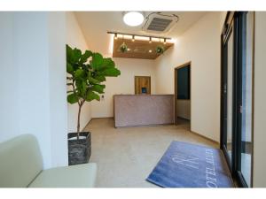 an office corridor with a table and a potted plant at HOTEL ALL IN Kumamoto - Vacation STAY 55149v in Hanabatachō