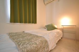 a bedroom with a bed with a green curtain at Kapalua East-Kapalua West - Vacation STAY 20388 in Tokyo