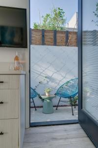 a sliding glass door leading to a patio with a table and chairs at Brand New Studio in Mar Vista in Los Angeles +6 photos
