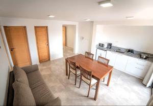 a living room with a table and a couch at departament en Añelo Neuquen in Añelo