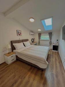 a bedroom with a large bed and a window at AdisiTi S1 in Zagreb