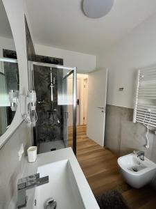 a white bathroom with a sink and a toilet at Residence Pelin in Treviso