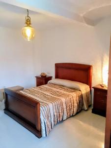 a bedroom with a bed and two night stands at Los Rosales de la Charca in Pegalajar