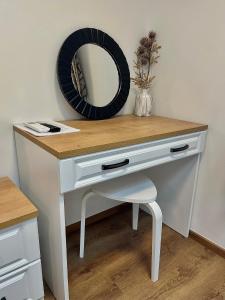a white desk with a mirror and a chair at AdisiTi S1 in Zagreb