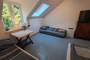 a room with a bed and a table and a window at Stara Szkoła S7 Noclegi Mazury, Zajezierze 8 14-330 Małdyty in Małdyty