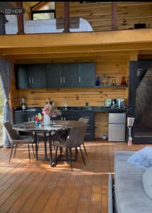 a kitchen and dining room with a table and chairs at La Cabaña 16 Mazamitla in Mazamitla