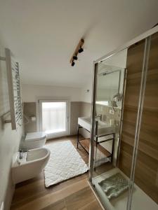 a bathroom with a glass shower and a sink at Residence Pelin in Treviso