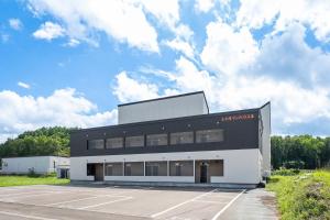 a large black building with a parking lot at Charmant House III - Vacation STAY 20373 in Minamifurano