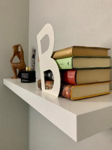 a stack of books sitting on top of a shelf at La Casa di Katia in Mantova