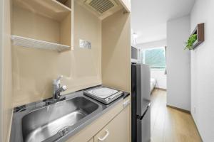 a small kitchen with a sink and a refrigerator at Charmant House III - Vacation STAY 20371 in Minamifurano +62 photos