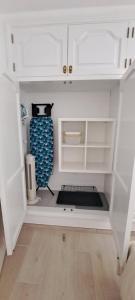 a small kitchen with white cabinets and a kitchen at Punta Panoramic - Punta Mujeres in Punta Mujeres +35 photos