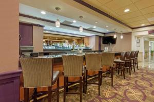 Un bar en un restaurante con sillas y una barra. en DoubleTree by Hilton Downtown Wilmington - Legal District, en Wilmington