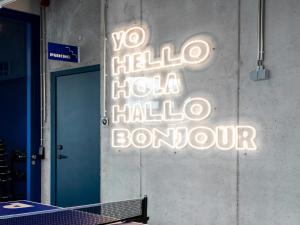 a neon sign on the wall of a tennis court at Adagio Access Gent Centrum Dampoort in Ghent