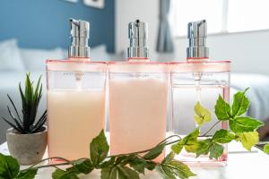 two bottles of liquid on a table with plants at Charmant House III - Vacation STAY 20396 in Minamifurano