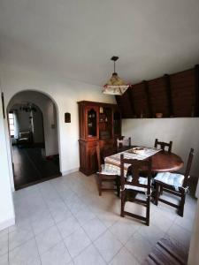 a dining room with a table and chairs in a room at Alpino Mitre in Mar de Ajó +11 photos