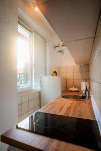 a kitchen with a sink and a refrigerator at Apartman Gnječ Kupres in Kupres