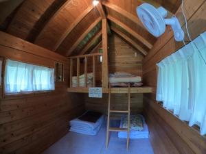a room with a bunk bed in a wooden cabin at Nikko Manaka Forest Camp & Resort - Vacation STAY 65320v in Nikko
