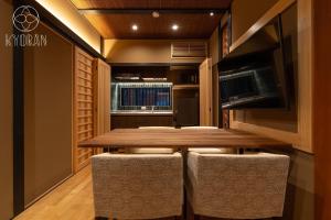 ein Esszimmer mit einem Holztisch und Stühlen in der Unterkunft [Kyoran Touen Residence] - Vacation STAY 65169v in Kyōto