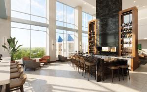 苏福尔斯Highpoint Hotel的大堂设有带椅子和大窗户的酒吧