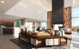 苏福尔斯Highpoint Hotel的客厅里有一张沙发和一张桌子。