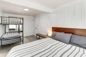 a bedroom with a bed and a bunk bed at Lake Access! All-Season Fun at Reed City Home in Reed City