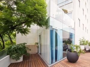 a glass facade of a building with plants at Mondrian Mexico City Condesa in Mexico City