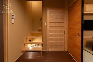 a walk in closet with wooden shelves and a door at Jinglan Nanshan - Vacation STAY 65363v in Kyōto