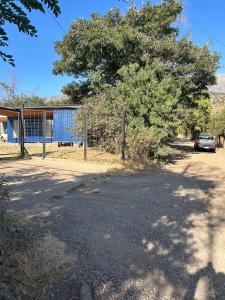 a car parked next to a fence and a tree at Depto Independiente Mostazal in La Punta +5 photos