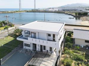 a white house with a view of the water at Nostalgia Oiso Awaji - Vacation STAY 66330v in Kusumoto
