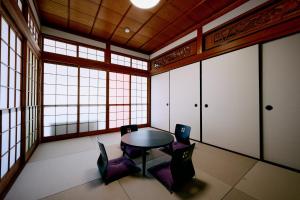 a room with a table and chairs and windows at Nostalgia Oiso Awaji - Vacation STAY 66330v in Kusumoto