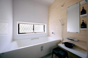 a bathroom with a large tub and a window at Nostalgia Oiso Awaji - Vacation STAY 66330v in Kusumoto +53 photos