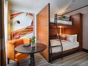 a bedroom with a bunk bed with a table and a chair at 21c Museum Hotel St Louis in Saint Louis +86 photos