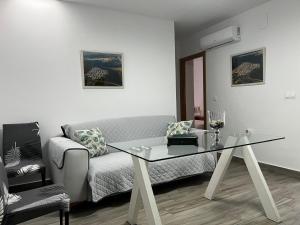 a living room with a couch and a glass table at La casita de la punta in Isla del Moral