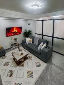 a living room with a couch and a table at Urban Shell Retreat- Kileleshwa in Nairobi