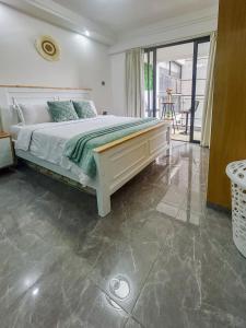 a bedroom with a large bed and a balcony at Urban Shell Retreat- Kileleshwa in Nairobi