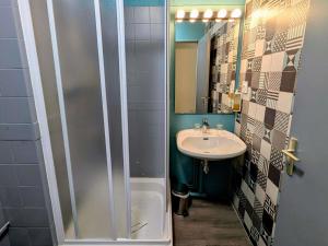 a small bathroom with a sink and a shower at greet Grenoble Centre Gare Accor Hotel in Grenoble