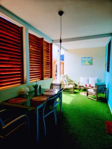 a living room with a table and chairs and a couch at Evasion en plein cœur de la ville T3 Jacuzzis Sauna et piscine au centre de Port-Louis in Port-Louis +25 photos