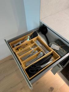 a drawer in a kitchen with utensils in it at Adoffi Apartment in Rakvere
